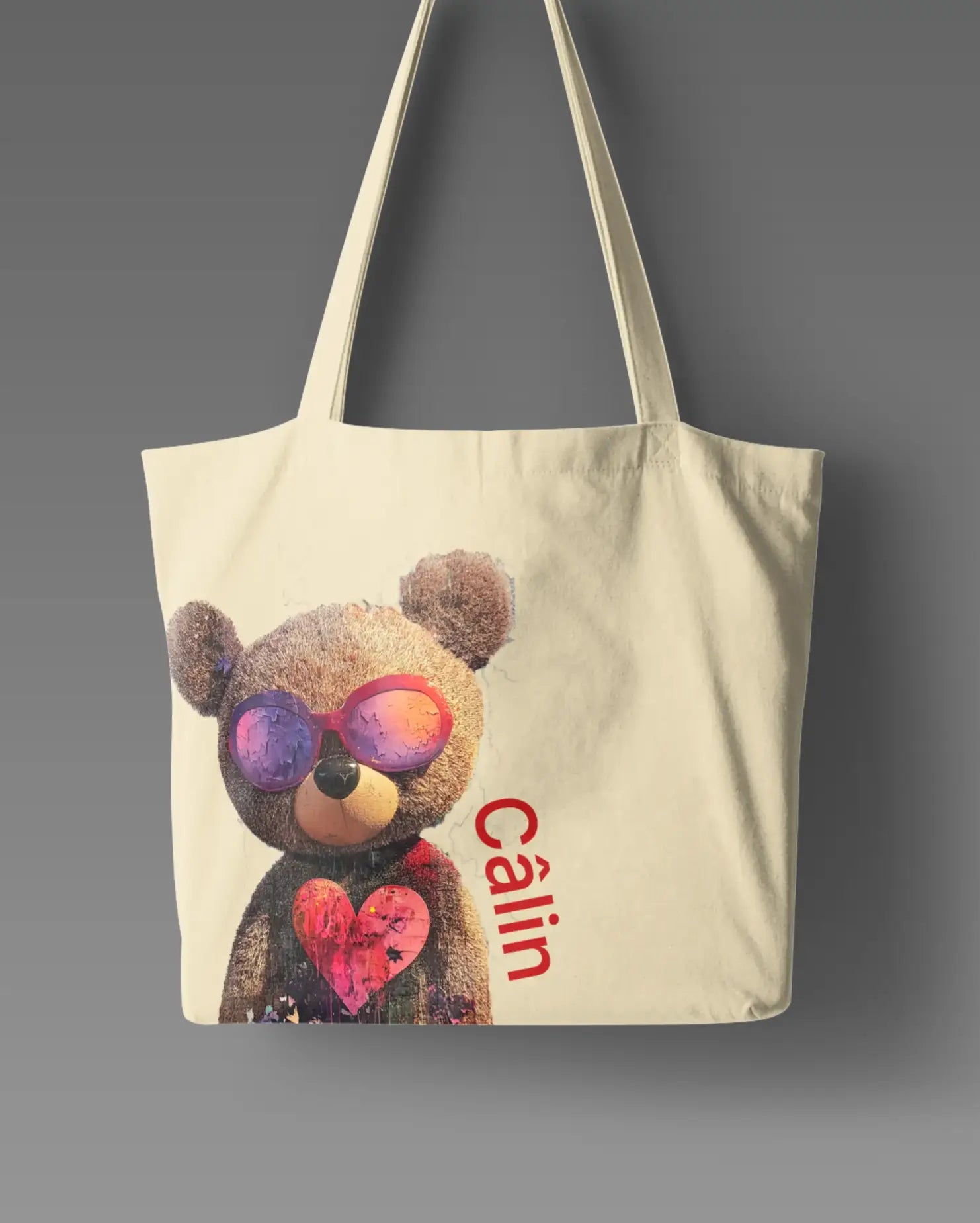 Câlin Tote bag featuring an adorable teddy bear wearing sunglasses and holding a heart, with ‘Câlin’ text written along the side, symbolizing love and care.