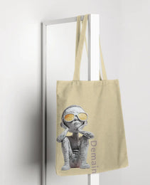 Demain Tote bag featuring a captivating design of a boy in sunglasses gazing upward, symbolizing hope, curiosity, and connection to the future, with ‘Demain’ text printed along the side.